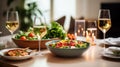 Fine restaurant dinner table place setting: napkin, wineglass, plate, bread and salad. Royalty Free Stock Photo