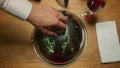 Fine restaurant dish lid cloche on table. Waiter hand presenting dinner meal. Royalty Free Stock Photo