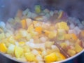 Finely chopped apples and oranges stew in a saucepan with cinnamon stick and spices Royalty Free Stock Photo