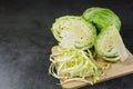 Finely chopped cabbage on a chopping board And cauliflower on black ground