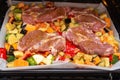 Finely chopped and seasoned vegetables with pork, placed on a baking sheet, before baking on parchment in the oven. Potatoes, bell Royalty Free Stock Photo