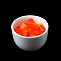 Finely chopped sweet peppers in a ceramic white cup on a black background Royalty Free Stock Photo