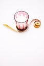 Healthy nutrition and diet concept - Elegant red crystal glass full of organic milk wrapped in a flexible tailor ruler on white Royalty Free Stock Photo
