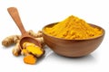 Finely dried Turmeric (Curcuma longa Linn) powder in a wooden bowl and spoon with rhizome (root) isolated on white background