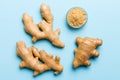 Finely dry Ginger powder in bowl with green leaves isolated on colored background. top view flat lay Royalty Free Stock Photo