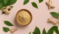 Finely dry Ginger powder in bowl with green leaves isolated on colored background. top view flat lay Royalty Free Stock Photo