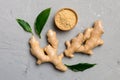 Finely dry Ginger powder in bowl with green leaves isolated on colored background. top view flat lay Royalty Free Stock Photo