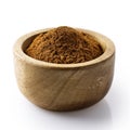 Finely ground cinnamon in dark wood bowl.