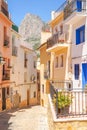 Finestrat, Spain - 12 June 2019: Narrow street in Finestrat old town with beautiful houses and Puig Campana mountain
