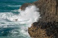 The Pacific ocean crashes into the columnar basalt rocks of Fingal Head, New South Wales