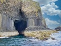 Fingal`s Cave surrounded by columns of jointed volcanic basalt rocks on the island of Staffa in Scotland Royalty Free Stock Photo