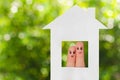 Finger art of a family. Family looking out of the window of the house out of paper. Royalty Free Stock Photo