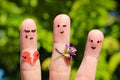 Finger art of family. Man gives bouquet of flowers to another woman.