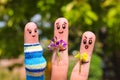 Finger art of Happy couple. Man is giving flowers pregnant woman.