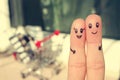 Finger art of a Happy couple. A man and a woman hug on the background shopping cart. Royalty Free Stock Photo