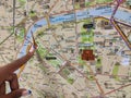 A finger of a black woman pointing at the eiffel tower symbol on a subway map, Paris, France Royalty Free Stock Photo