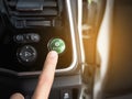 Finger at energy save mode button of eco car with light flare Royalty Free Stock Photo