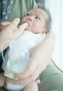 Finger Feeding breast milk to newborn baby boy using small tube