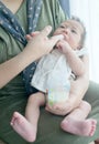 Finger Feeding breast milk to newborn baby boy using small tube
