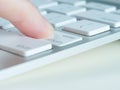 Finger of female is pressing enter key of a computer keyboard Royalty Free Stock Photo