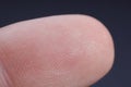 Finger with friction ridges on dark background, macro view Royalty Free Stock Photo