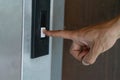 Finger Hand pressing electronic control. Male push the down bottom on the dirty loading elevator building Royalty Free Stock Photo