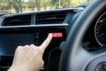 Finger hitting car emergency light botton in car. Royalty Free Stock Photo