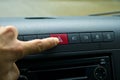 Finger hitting car emergency red light button in the car Royalty Free Stock Photo