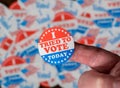 Finger with I Tried to Vote sticker in front of many election voting badges with problems getting a vote Royalty Free Stock Photo