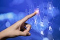A finger interacting with a hexagonal digital interface displaying security icons