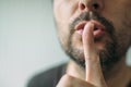 Finger on lips, man gesturing shhh sign Royalty Free Stock Photo