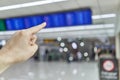 Finger of man is pointing at blur flight schedule