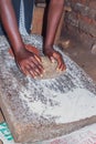 Finger millet Eleusine coracana being crushed into flour for porridge, Uganda