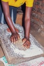 Finger millet Eleusine coracana being crushed into flour for porridge, Uganda