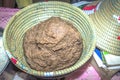 Finger millet Eleusine coracana being crushed into flour for porridge, Uganda