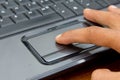 Finger on notebook touchpad. Royalty Free Stock Photo