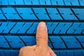 Finger with old blue tire Royalty Free Stock Photo