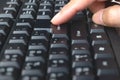 Finger of person touching computer keyboard. Royalty Free Stock Photo