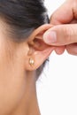 Finger pinching woman's ear Royalty Free Stock Photo