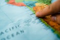 Finger pointing at Chile on a map. Selective focus on label Royalty Free Stock Photo