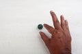 Finger pointing a marble ball Royalty Free Stock Photo