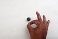 Finger pointing a marble ball Royalty Free Stock Photo