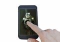 Finger pointing on mobile phone touch screen and gun muzzle with smoke floating in white background