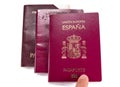 Finger pointint new spanish passport over old expired ones Royalty Free Stock Photo