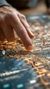 A finger points to a glowing spot on a digital map filled with 3D location pins and network routes, symbolizing Royalty Free Stock Photo