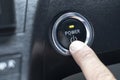 Finger on a power button to push start the car engine Royalty Free Stock Photo