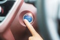 Finger press a car ignition button or START engine inside modern electric automobile. Keyless, change, strategy, vision, Royalty Free Stock Photo