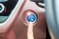 Finger press a car ignition button or START engine inside modern electric automobile. Keyless, change, strategy, vision, Royalty Free Stock Photo