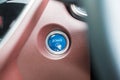 Finger press a car ignition button or START engine inside modern electric automobile. Keyless, change, strategy, vision, Royalty Free Stock Photo