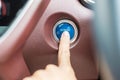 Finger press a car ignition button or START engine inside modern electric automobile. Keyless, change, strategy, vision, Royalty Free Stock Photo